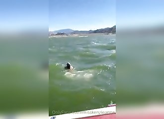 Blonde undresses before diving into the water
